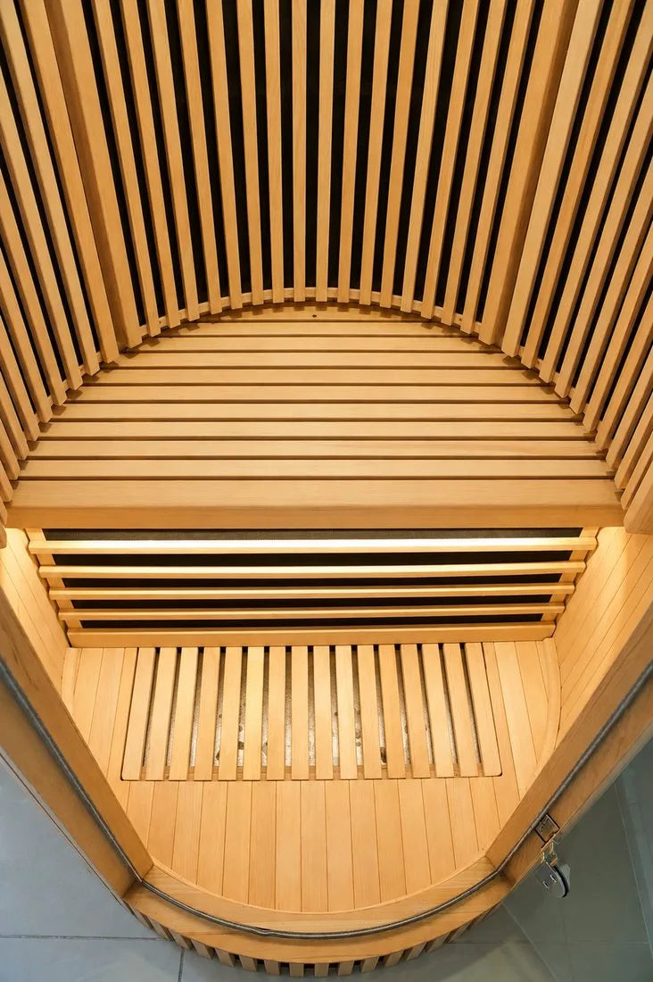 Canadian hemlock wood bench and slatted interior of the Recover Circle infrared sauna